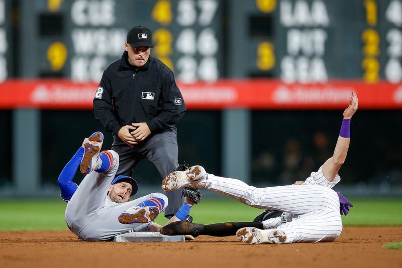 May 26, 2023; Denver, Colorado, USA; Colorado Rockies first baseman Nolan Jones (22) is tagged out at second by New York Mets second baseman Jeff McNeil (1) as umpire Jansen Visconti (52) looks on in the ninth inning at Coors Field. Mandatory Credit: Isaiah J. Downing-USA TODAY Sports