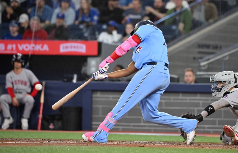 May 1, 2025; Toronto, Ontario, CAN;  Toronto Blue Jays first baseman Vladimir Guerrero Jr. (27) hits a three run home run against the Boston Red Sox in the eighth inning at Rogers Centre. Mandatory Credit: Dan Hamilton-Imagn Images