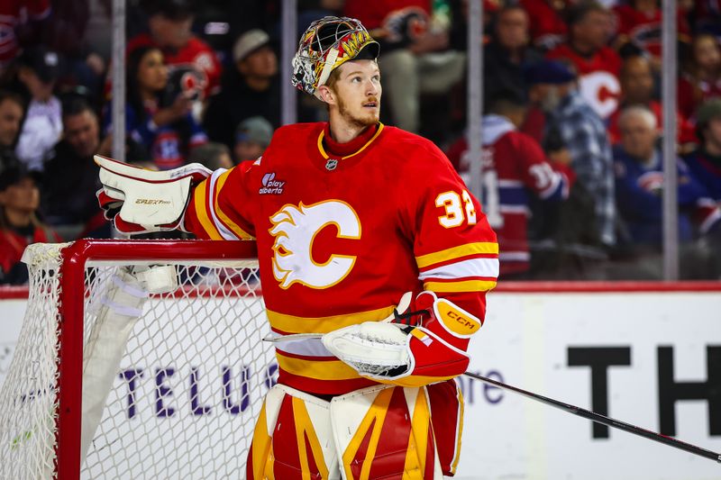 Oct 22, 2025; Calgary, Alberta, CAN; Calgary Flames goaltender Dustin Wolf (32) reacts during the first period against the Montreal Canadiens at Scotiabank Saddledome. Mandatory Credit: Sergei Belski-Imagn Images
