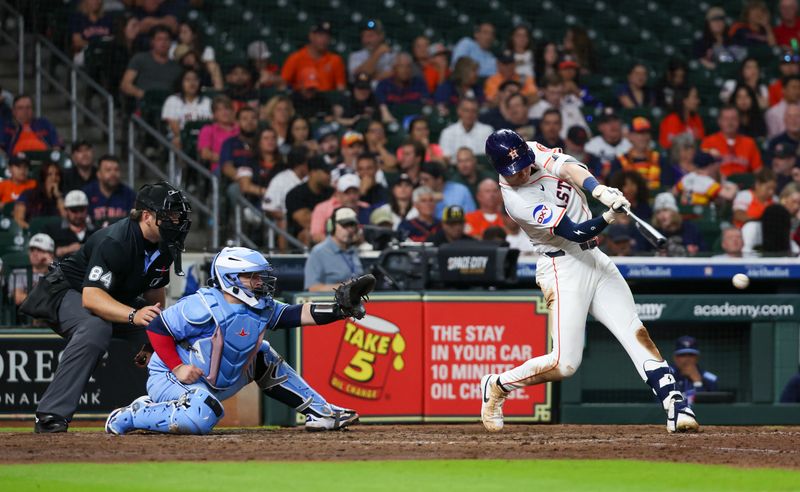 Apr 23, 2025; Houston, Texas, USA; Houston Astros right fielder Zach Dezenzo (9) hits a single against the Toronto Blue Jays in the eighth inning at Daikin Park. Mandatory Credit: Thomas Shea-Imagn Images