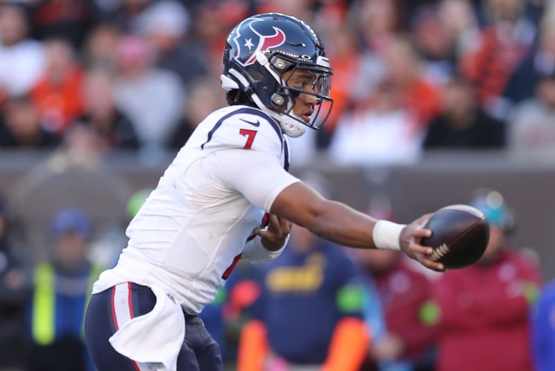 Houston Texans quarterback C.J. Stroud (7) hands off the ball during to an NFL football game against the Cincinnati Bengals, Sunday, Nov. 12, 2023, in Cincinnati. (AP Photo/Melissa Tamez)