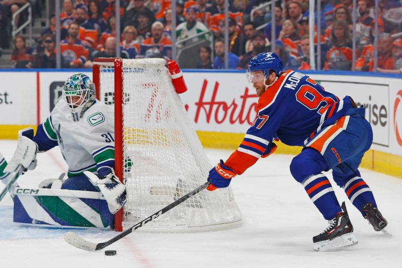 May 14, 2024; Edmonton, Alberta, CAN; Edmonton Oilers forward Connor McDavid (97) looks to make a pass in front of Vancouver Canucks goaltender Arturs Silovs (31) during the first period in game four of the second round of the 2024 Stanley Cup Playoffs at Rogers Place. Mandatory Credit: Perry Nelson-USA TODAY Sports