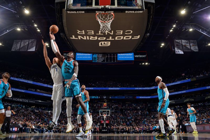 PHOENIX, AZ - JANUARY 26: Deandre Ayton #22 of the Phoenix Suns rebounds the ball during the game against the Dallas Mavericks on January 26, 2022 at Footprint Center in Phoenix, Arizona. NOTE TO USER: User expressly acknowledges and agrees that, by downloading and or using this photograph, user is consenting to the terms and conditions of the Getty Images License Agreement. Mandatory Copyright Notice: Copyright 2022 NBAE (Photo by Barry Gossage/NBAE via Getty Images)