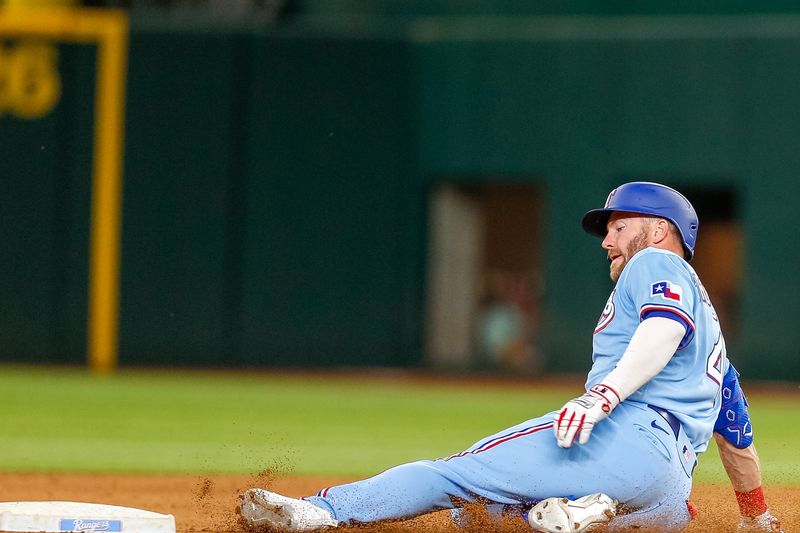 Apr 2, 2023; Arlington, Texas, USA; Texas Rangers right fielder Robbie Grossman (4) slides in for a double during the seventh inning against the Philadelphia Phillies at Globe Life Field. Mandatory Credit: Andrew Dieb-USA TODAY Sports