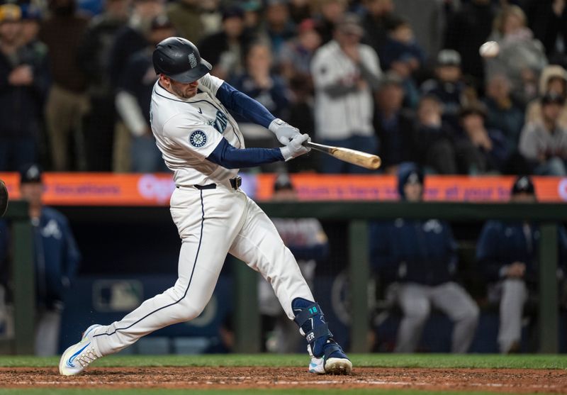 Apr 29, 2024; Seattle, Washington, USA; Seattle Mariners designated hitter Mitch Garver (18) hits a two-run home run during the ninth inning against the Atlanta Braves at T-Mobile Park. Mandatory Credit: Stephen Brashear-USA TODAY Sports