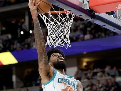 DENVER, COLORADO - JANUARY 01: Nick Richards #4 of the Charlotte Hornets goes to the basket against Nikola Jokic #15 of the Denver Nuggets in the third quarter at Ball Arena on January 01, 2024 in Denver, Colorado. NOTE TO USER: User expressly acknowledges and agrees that, by downloading and or using this photograph, User is consenting to the terms and conditions of the Getty Images License Agreement.   (Photo by Matthew Stockman/Getty Images)