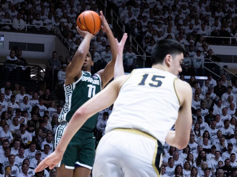 Jan 29, 2023; West Lafayette, Indiana, USA; Michigan State Spartans guard A.J. Hoggard (11) shoots the ball while Purdue Boilermakers center Zach Edey (15) defends in the first half at Mackey Arena. Mandatory Credit: Trevor Ruszkowski-USA TODAY Sports