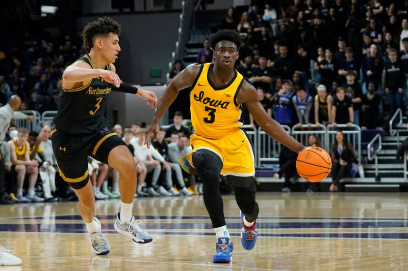 Feb 28, 2025; Evanston, Illinois, USA; Northwestern Wildcats guard Ty Berry (3) defends Iowa Hawkeyes guard Drew Thelwell (3) during the first half at Welsh-Ryan Arena. Mandatory Credit: David Banks-Imagn Images