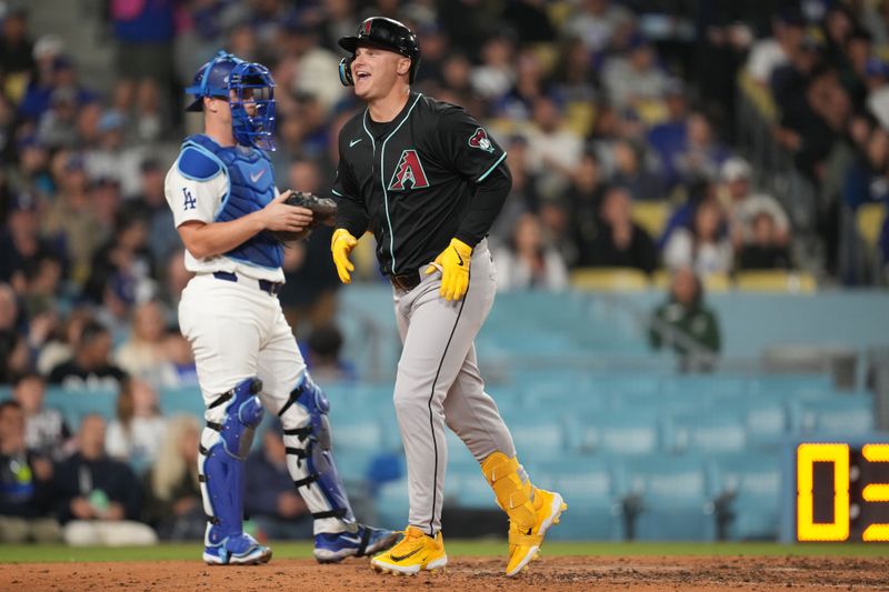 May 21, 2024; Los Angeles, California, USA; Arizona Diamondbacks designated hitter Joc Pederson (3) crosses home plate after hitting a three-run home run in the seventh inning as Los Angeles Dodgers catcher Will Smith (16) watches at Dodger Stadium. Mandatory Credit: Kirby Lee-USA TODAY Sports