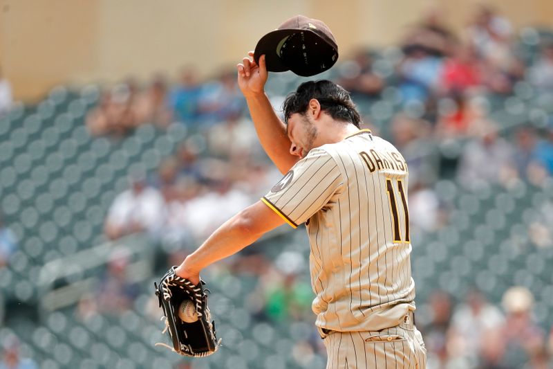 May 11, 2023; Minneapolis, Minnesota, USA; San Diego Padres starting pitcher Yu Darvish (11) reacts after giving up a run on a walk to the Minnesota Twins in the first inning at Target Field. Mandatory Credit: Bruce Kluckhohn-USA TODAY Sports