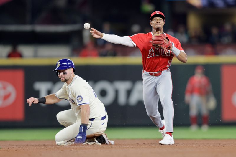 Jun 2, 2024; Seattle, Washington, USA; Seattle Mariners catcher Cal Raleigh (29) is forced out at second as Los Angeles Angels second base Luis Guillorme (15) throws to fist to complete a double play on Mariners’ Ty France at T-Mobile Park. Mandatory Credit: John Froschauer-USA TODAY Sports