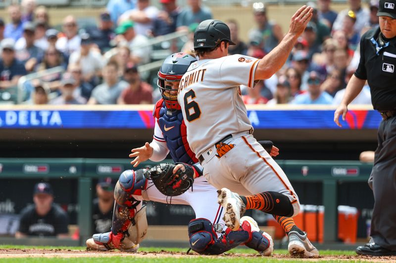 May 24, 2023; Minneapolis, Minnesota, USA; Minnesota Twins catcher Ryan Jeffers (27) fields the ball to tag out San Francisco Giants third baseman Casey Schmitt (6) at home plate during the second inning at Target Field. Mandatory Credit: Matt Krohn-USA TODAY Sports
