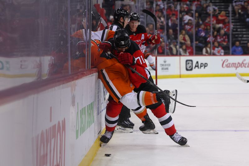 Oct 27, 2024; Newark, New Jersey, USA; New Jersey Devils defenseman Jonas Siegenthaler (71) hits Anaheim Ducks center Robby Fabbri (13) during the third period at Prudential Center. Mandatory Credit: Ed Mulholland-Imagn Images