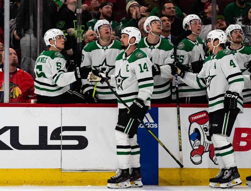 Apr 6, 2024; Chicago, Illinois, USA; Dallas Stars left winger Jamie Benn (14) high-fives teammates while waiting for referees to review his successful goal against the Chicago Blackhawks during the third period at United Center. Mandatory Credit: Seeger Gray-USA TODAY Sports