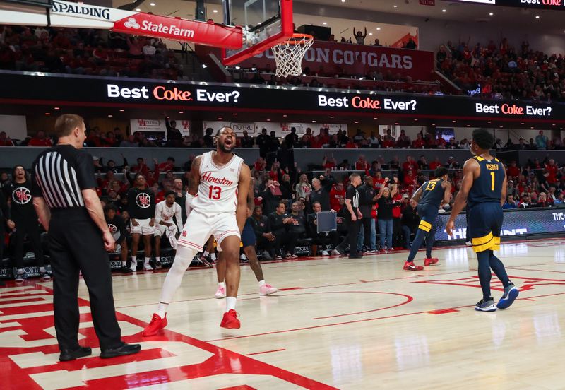 Jan 15, 2025; Houston, Texas, USA;  Houston Cougars forward J'Wan Roberts (13) reacts to his dunk against the West Virginia Mountaineers in the second half at Fertitta Center. Mandatory Credit: Thomas Shea-Imagn Images