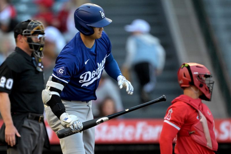 Mar 26, 2024; Anaheim, California, USA; Los Angeles Dodgers designated hitter Shohei Ohtani (17) checks his bat in the first inning against the Los Angeles Angels at Angel Stadium. Mandatory Credit: Jayne Kamin-Oncea-USA TODAY Sports