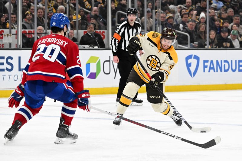 Jan 20, 2024; Boston, Massachusetts, USA; Boston Bruins defenseman Matt Grzelcyk (48) takes a shot in front of Montreal Canadiens left wing Juraj Slafkovsky (20) during the third period at the TD Garden. Mandatory Credit: Brian Fluharty-USA TODAY Sports