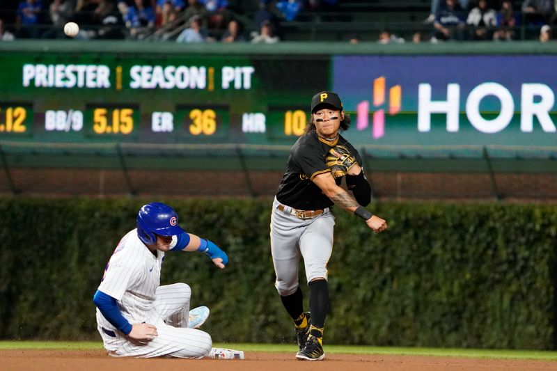 Sep 19, 2023; Chicago, Illinois, USA; Pittsburgh Pirates second baseman Ji Hwan Bae (3) forces out Chicago Cubs left fielder Ian Happ (8) at second base during the sixth inning at Wrigley Field. Mandatory Credit: David Banks-USA TODAY Sports