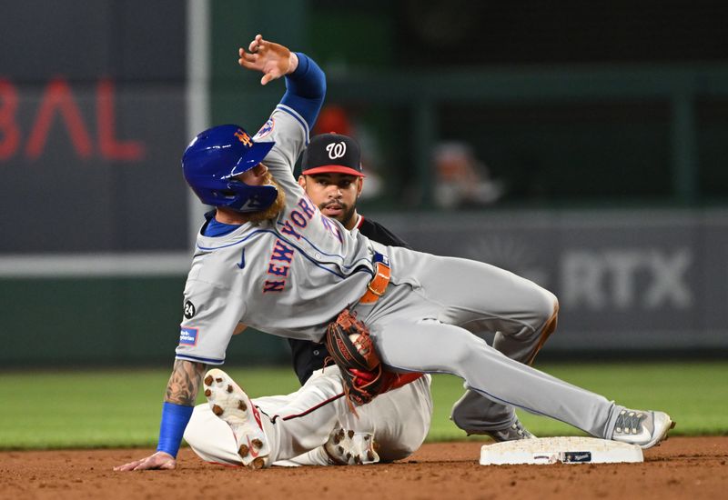 Jul 2, 2024; Washington, District of Columbia, USA; New York Mets left fielder Ben Gamel (21) falls over Washington Nationals second baseman Luis Garcia Jr. (2) after stealing second base during the tenth inning at Nationals Park. Mandatory Credit: Rafael Suanes-USA TODAY Sports