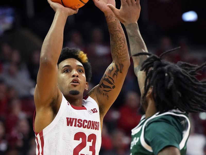 Nov 15, 2022; Madison, Wisconsin, USA; Wisconsin Badgers guard Chucky Hepburn (23) shoots under coverage by Green Bay Phoenix guard Zae Blake (5) during the second half at the Kohl Center. Mandatory Credit: Kayla Wolf-USA TODAY Sports