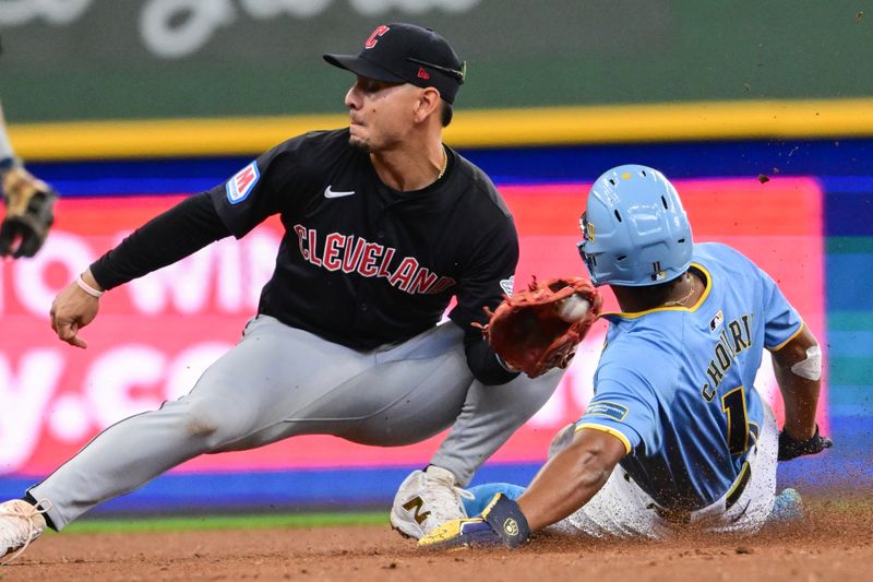 Aug 18, 2024; Milwaukee, Wisconsin, USA; Milwaukee Brewers left fielder Jackson Chourio (11) steals second base before tag by Cleveland Guardians second baseman Andres Gimenez (0) in the fifth inning at American Family Field. Mandatory Credit: Benny Sieu-USA TODAY Sports