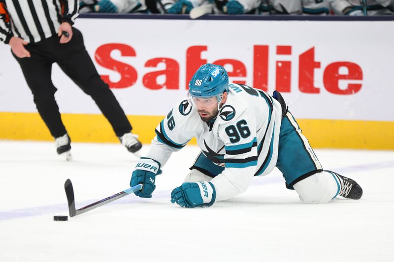 Jan 16, 2025; Columbus, Ohio, USA;  San Jose Sharks defenseman Jake Walman (96) reaches for the puck during the second period against the Columbus Blue Jackets at Nationwide Arena. Mandatory Credit: Joseph Maiorana-Imagn Images