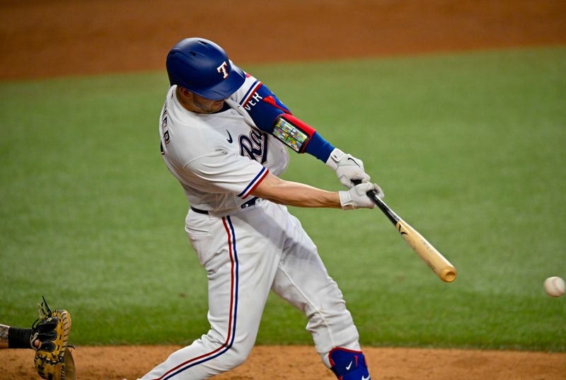 Aug 3, 2023; Arlington, Texas, USA; Texas Rangers catcher Mitch Garver (18) hits a single and drives in a run against the Chicago White Sox during the eighth inning at Globe Life Field. Mandatory Credit: Jerome Miron-USA TODAY Sports