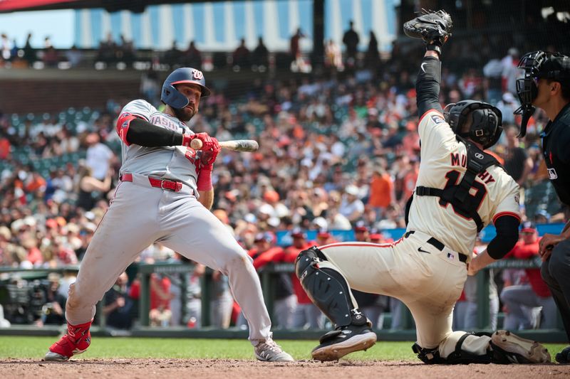 Apr 10, 2024; San Francisco, California, USA; Washington Nationals first baseman Joey Gallo (24) leans back to avoid an inside pitch against San Francisco Giants catcher Tom Murphy (19) during the ninth inning at Oracle Park. Mandatory Credit: Robert Edwards-USA TODAY Sports