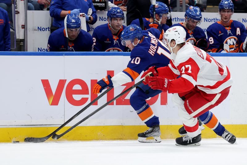 Oct 22, 2024; Elmont, New York, USA; New York Islanders right wing Simon Holmstrom (10) fights for the puck against Detroit Red Wings defenseman Simon Edvinsson (77) during the second period at UBS Arena. Mandatory Credit: Brad Penner-Imagn Images