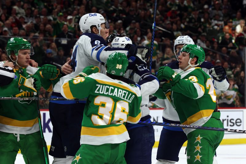 Apr 6, 2024; Saint Paul, Minnesota, USA; Winnipeg Jets defenseman Logan Stanley (64) challenges Minnesota Wild center Marco Rossi (23) during the second period at Xcel Energy Center. Mandatory Credit: Bruce Fedyck-USA TODAY Sports