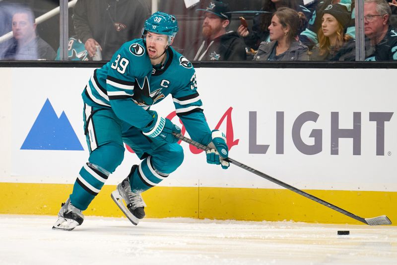 Jan 30, 2024; San Jose, California, USA; San Jose Sharks center Logan Couture (39) plays the puck against the Seattle Kraken during the second period at SAP Center at San Jose. Mandatory Credit: Robert Edwards-USA TODAY Sports