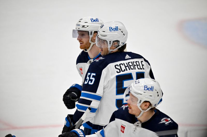 Apr 11, 2024; Dallas, Texas, USA; Winnipeg Jets left wing Kyle Connor (81) and center Mark Scheifele (55) celebrates a goal scored by Scheifele against the Dallas Stars during the third period at the American Airlines Center. Mandatory Credit: Jerome Miron-USA TODAY Sports