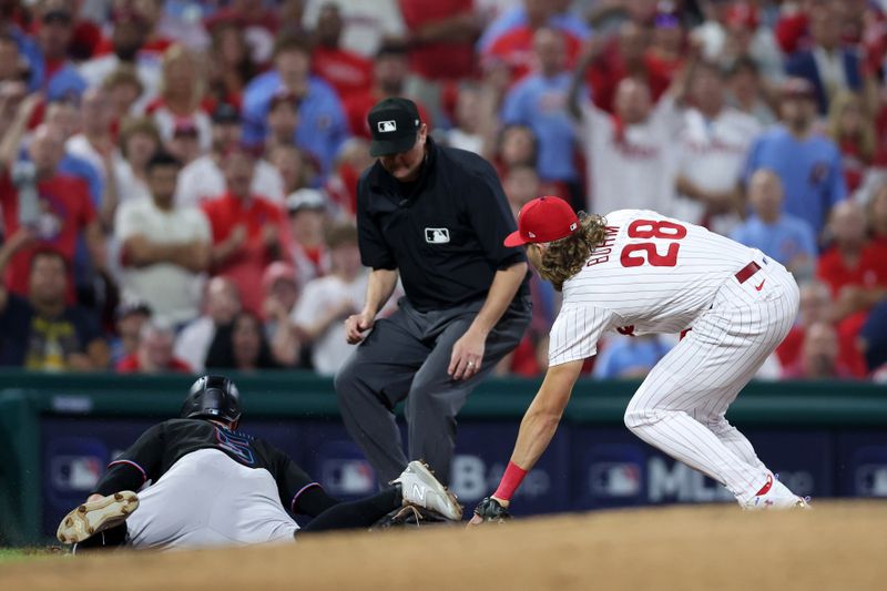 Oct 4, 2023; Philadelphia, Pennsylvania, USA; Philadelphia Phillies first baseman Alec Bohm (28) tags Miami Marlins shortstop Jon Berti (5) at third base during the third inning for game two of the Wildcard series for the 2023 MLB playoffs at Citizens Bank Park. Mandatory Credit: Bill Streicher-USA TODAY Sports