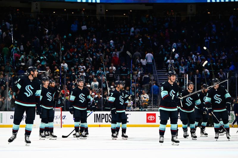 Oct 29, 2022; Seattle, Washington, USA; The Seattle Kraken celebrate after defeating the Pittsburgh Penguins at Climate Pledge Arena. Seattle won 3-1. Mandatory Credit: Steven Bisig-USA TODAY Sports