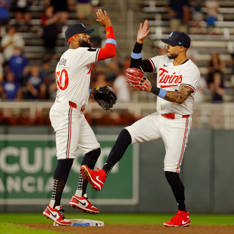 Jun 16, 2024; Minneapolis, Minnesota, USA; Minnesota Twins shortstop Willi Castro (50) and shortstop Carlos Correa (4) celebrate the win over the Oakland Athletics in game two of a double header at Target Field. Mandatory Credit: Bruce Kluckhohn-USA TODAY Sports