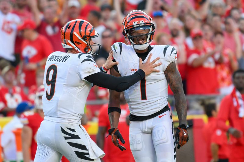 Cincinnati Bengals quarterback Joe Burrow (9) pushes Bengals wide receiver Ja'Marr Chase (1) away from the officials after Chase was angry about a play during the second half of an NFL football game against the Kansas City Chiefs, Sunday, Sept. 15, 2024 in Kansas City, Mo. The Chiefs defeated the Bengals, 26-25. (AP Photo/Reed Hoffmann)