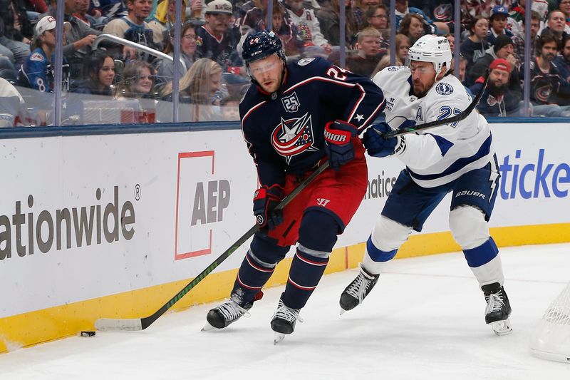 Oct 18, 2025; Columbus, Ohio, USA; Columbus Blue Jackets center Mathieu Olivier (24) passes the puck defended by Tampa Bay Lightning defenseman Ryan McDonagh (27) during the second period at Nationwide Arena. Mandatory Credit: Russell LaBounty-Imagn Images