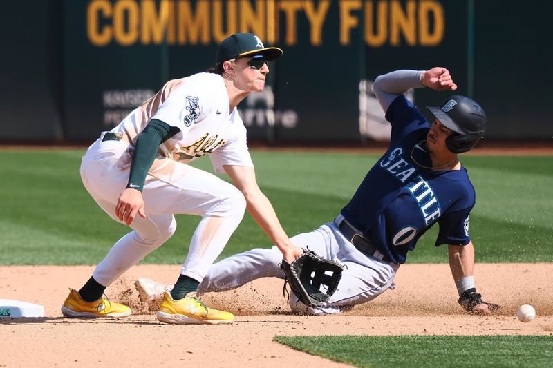 Sep 20, 2023; Oakland, California, USA; Seattle Mariners left fielder Sam Haggerty (0) steals second base against Oakland Athletics second baseman Zack Gelof (20) during the eighth inning at Oakland-Alameda County Coliseum. Mandatory Credit: Kelley L Cox-USA TODAY Sports