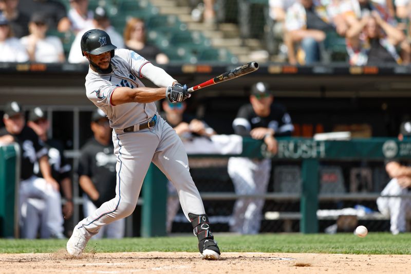 Jun 10, 2023; Chicago, Illinois, USA; Miami Marlins left fielder Bryan De La Cruz (14) reaches on a fielders choice against the Chicago White Sox during the ninth inning at Guaranteed Rate Field. Mandatory Credit: Kamil Krzaczynski-USA TODAY Sports