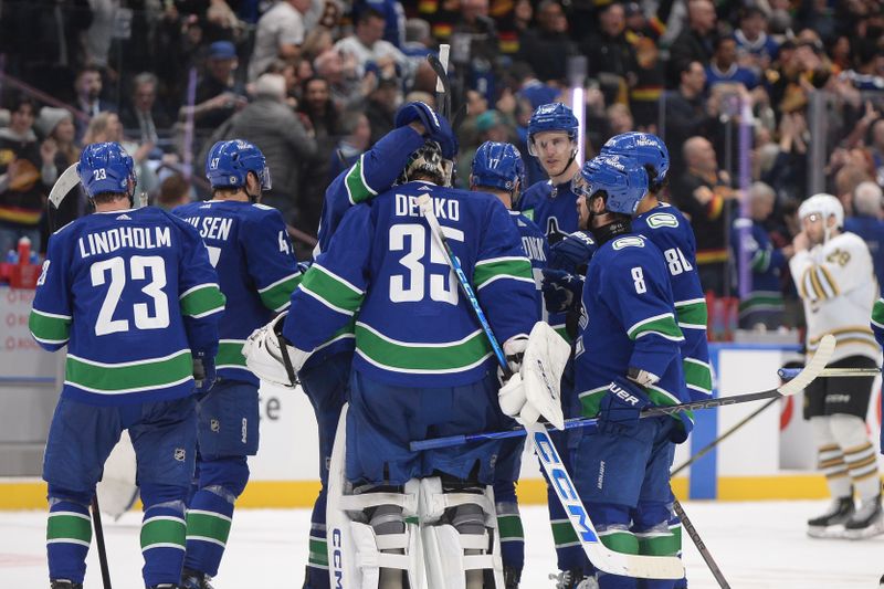 Feb 24, 2024; Vancouver, British Columbia, CAN;  The Vancouver Canucks celebrate the win in overtime against the Boston Bruins at Rogers Arena. Mandatory Credit: Anne-Marie Sorvin-USA TODAY Sports