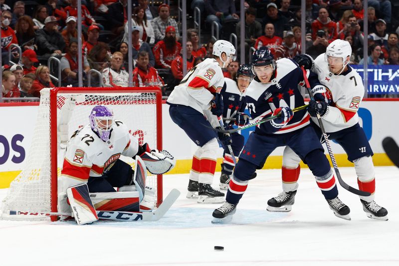 Nov 8, 2023; Washington, District of Columbia, USA; Washington Capitals right wing T.J. Oshie (77) and Florida Panthers defenseman Dmitry Kulikov (7) battle for the puck in front of Panthers goaltender Sergei Bobrovsky (72) in the first period at Capital One Arena. Mandatory Credit: Geoff Burke-USA TODAY Sports