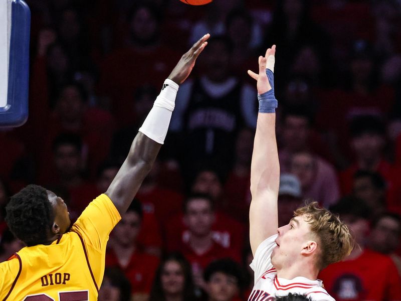 Jan 14, 2026; Tucson, Arizona, USA; Arizona Wildcats center Motiejus Krivas (13) makes a jumper over Arizona State Sun Devils center Massamba Diop (35) during the first half of the game at McKale Memorial Center. Mandatory Credit: Aryanna Frank-Imagn Images