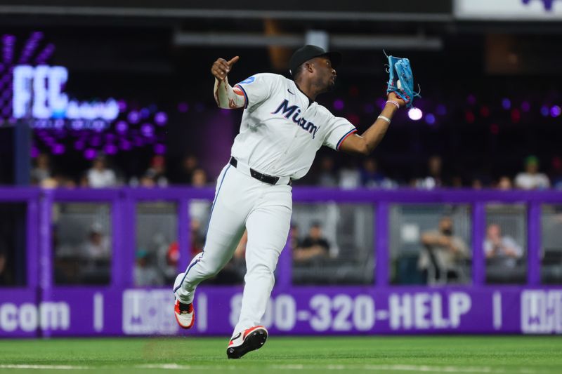 Sep 18, 2024; Miami, Florida, USA; Miami Marlins right fielder Jesus Sanchez (12) catches a fly ball to retire Los Angeles Dodgers shortstop Tommy Edman (not pictured) during the fifth inning at loanDepot Park. Mandatory Credit: Sam Navarro-Imagn Images