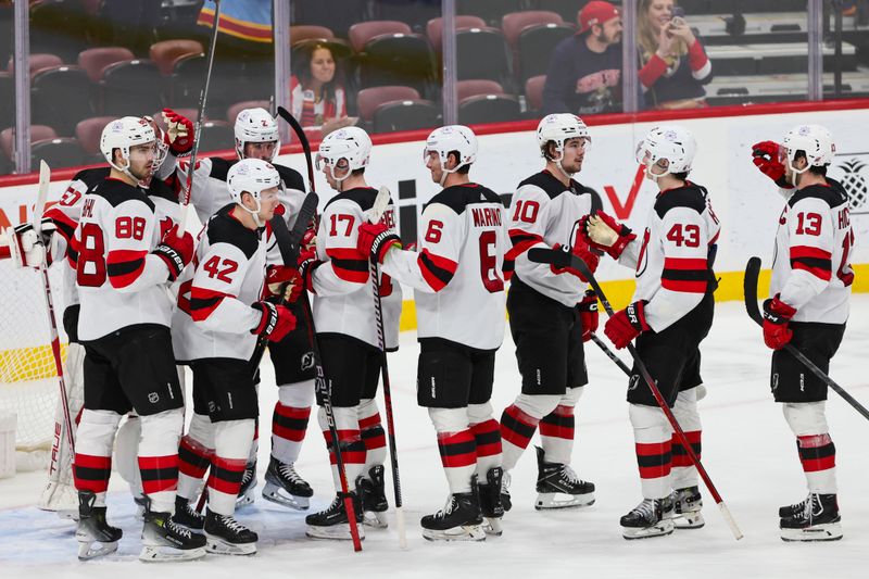 Jan 13, 2024; Sunrise, Florida, USA; New Jersey Devils players celebrate after winning the game against the Florida Panthers at Amerant Bank Arena. Mandatory Credit: Sam Navarro-USA TODAY Sports