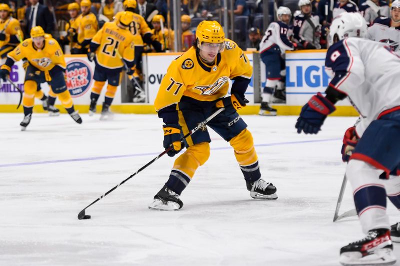 Apr 13, 2024; Nashville, Tennessee, USA; Nashville Predators right wing Luke Evangelista (77) takes a shot on goal against the Columbus Blue Jackets during the third period at Bridgestone Arena. Mandatory Credit: Steve Roberts-USA TODAY Sports