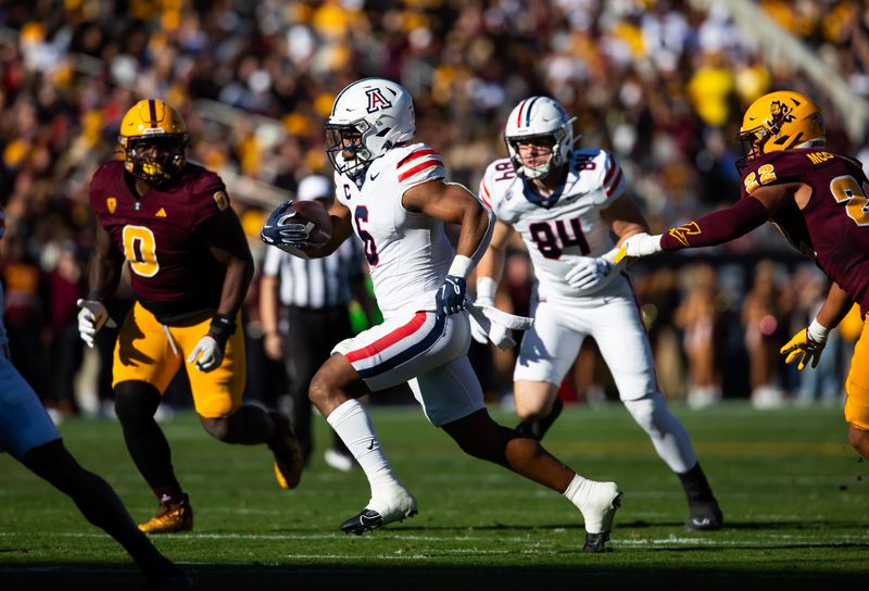 Nov 25, 2023; Tempe, Arizona, USA; Arizona Wildcats running back Michael Wiley (6) runs for a touchdown against the Arizona State Sun Devils in the first half of the Territorial Cup at Mountain America Stadium. Mandatory Credit: Mark J. Rebilas-USA TODAY Sports