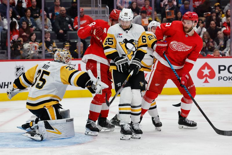 Oct 18, 2023; Detroit, Michigan, USA; Pittsburgh Penguins goaltender Tristan Jarry (35) makes a save in front of defenseman Erik Karlsson (65) and Detroit Red Wings center Michael Rasmussen (27) in the second period at Little Caesars Arena. Mandatory Credit: Rick Osentoski-USA TODAY Sports