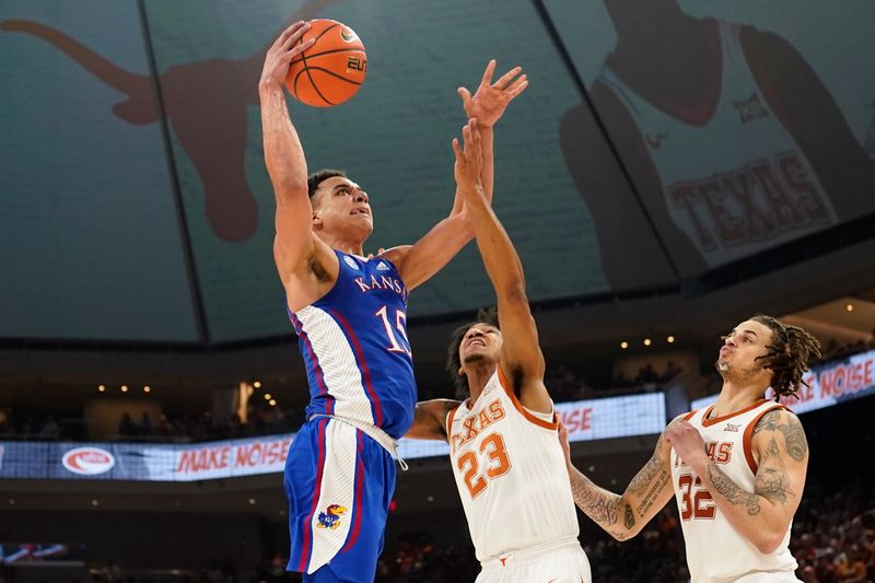 Mar 4, 2023; Austin, Texas, USA; Kansas Jayhawks guard Kevin McCullar Jr. (15) shoots over Texas Longhorns forwards Dillon Mitchell (23) and Christian Bishop (32) during the second half at Moody Center. Mandatory Credit: Scott Wachter-USA TODAY Sports