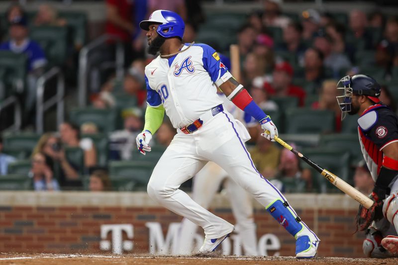 Aug 24, 2024; Atlanta, Georgia, USA; Atlanta Braves designated hitter Marcell Ozuna (20) hits a single against the Washington Nationals in the sixth inning at Truist Park. Mandatory Credit: Brett Davis-USA TODAY Sports