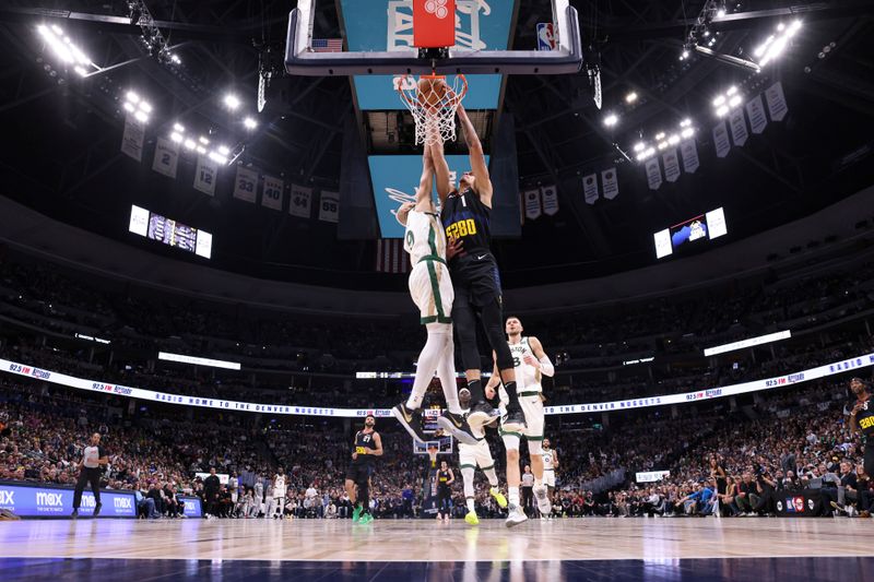 DENVER, COLORADO - MARCH 7: Michael Porter Jr. #1 of the Denver Nuggets dunks the ball over Derrick White #9 of the Boston Celtics during the first half of the game at Ball Arena on March 7, 2024 in Denver, Colorado. NOTE TO USER: User expressly acknowledges and agrees that, by downloading and or using this photograph, User is consenting to the terms and conditions of the Getty Images License Agreement. (Photo by Brendall O'Banon/Clarkson Creative/Getty Images)